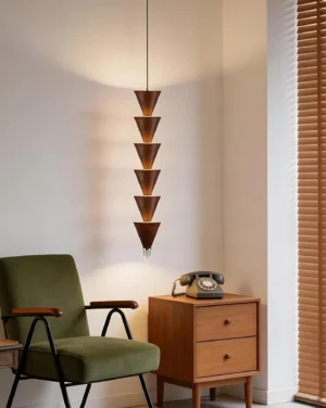 Modern stacked cone pendant hanging in mid-century modern lounge with vintage furniture and warm ambient lighting