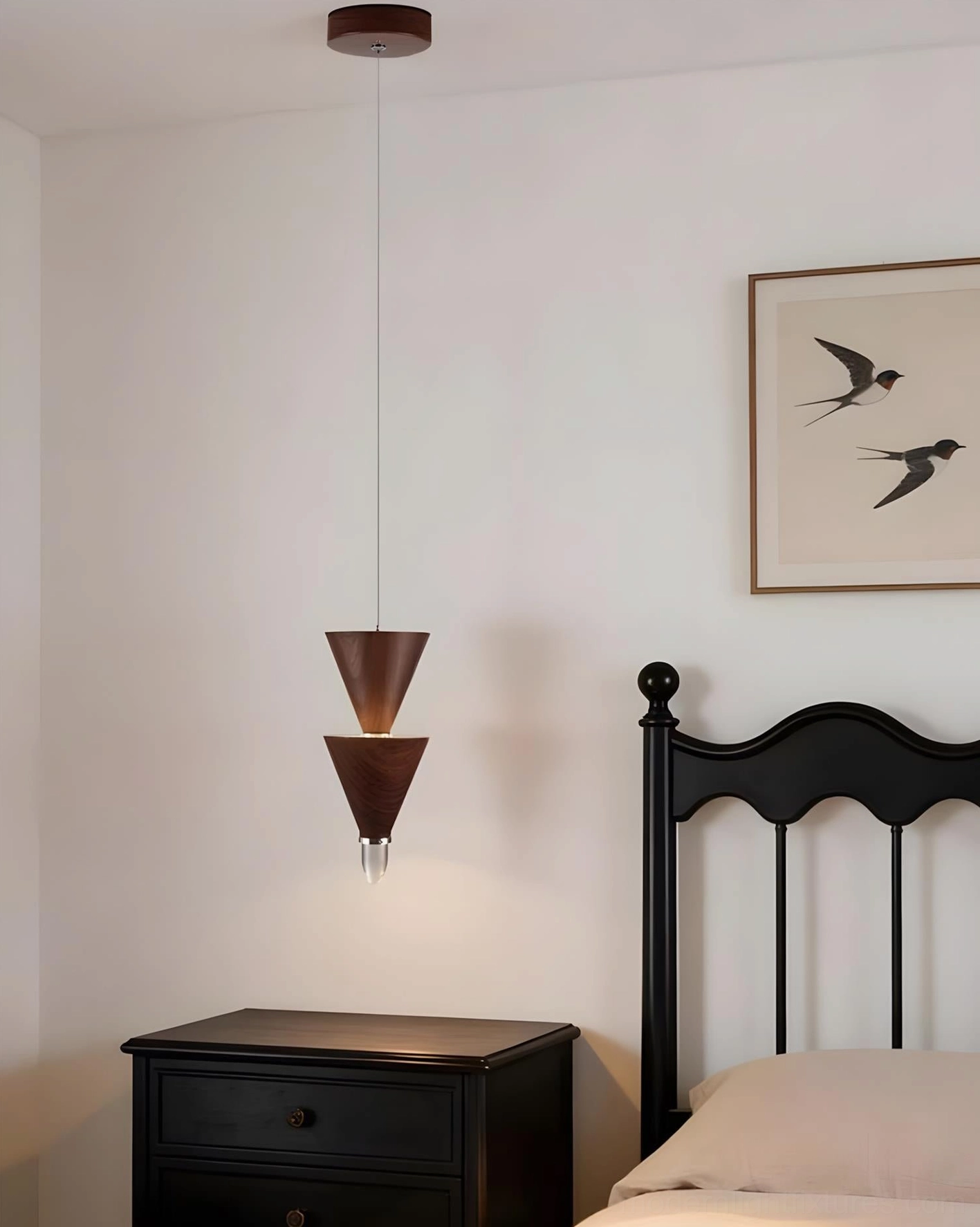 Minimalist bedroom with stacked cone pendant light above black nightstand and bird wall art