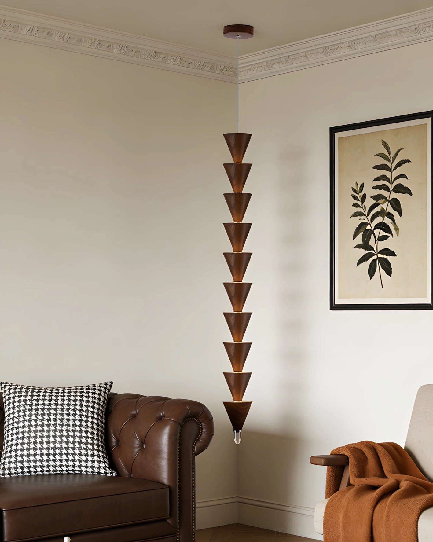 Tall stacked cone pendant light in vintage living room beside brown leather sofa with botanical print