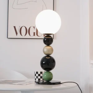 Stacked ball table lamp in living room interior with checkered artwork and contemporary home decor styling
