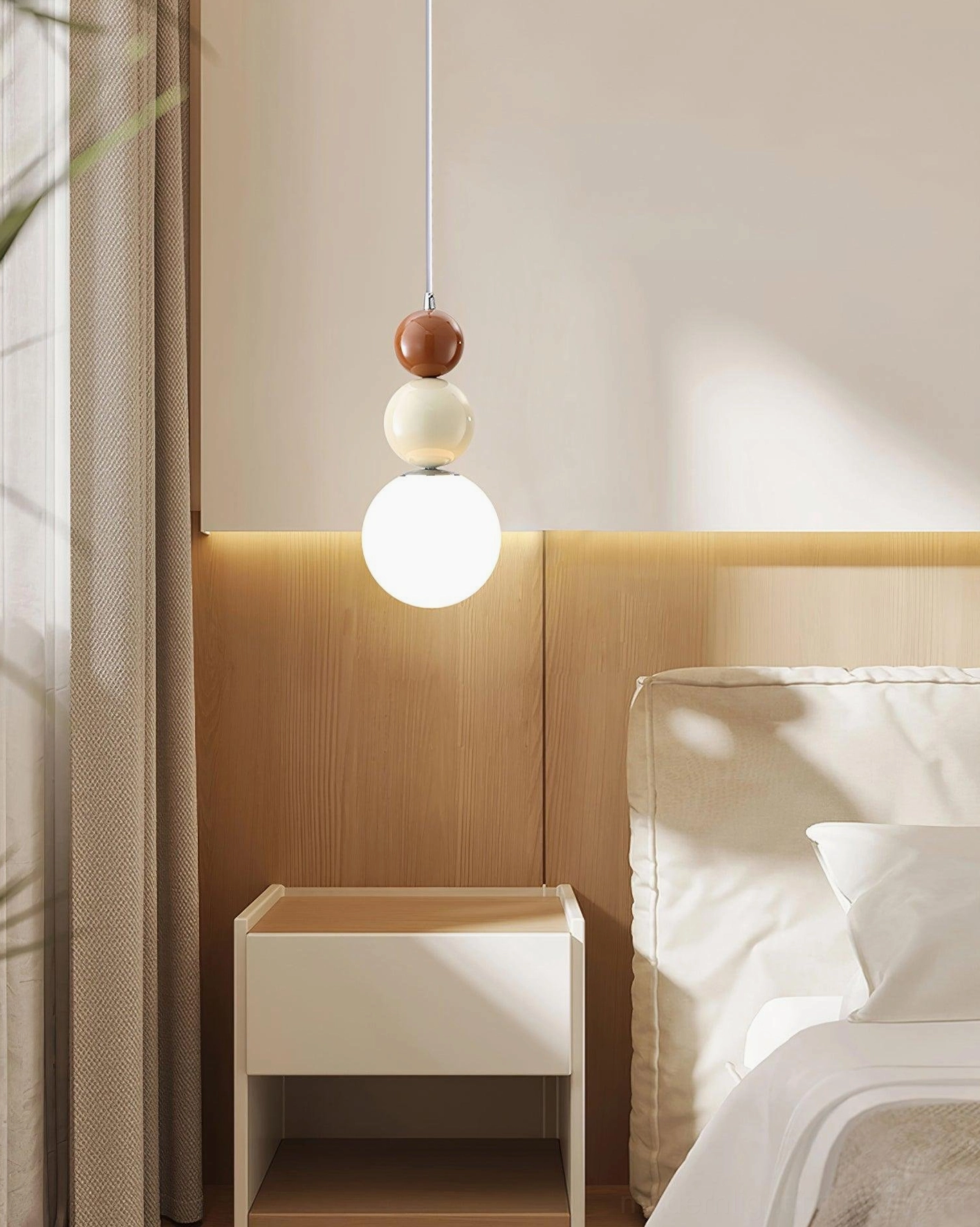 Modern kitchen with wooden dining island illuminated by three matching stacked glass ball pendant lights