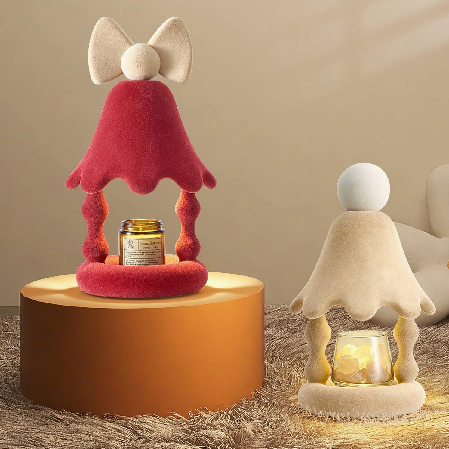 Beige and red Stacy candle warmer table lamps displayed in cozy home living room scene with fur rug and decorative styling