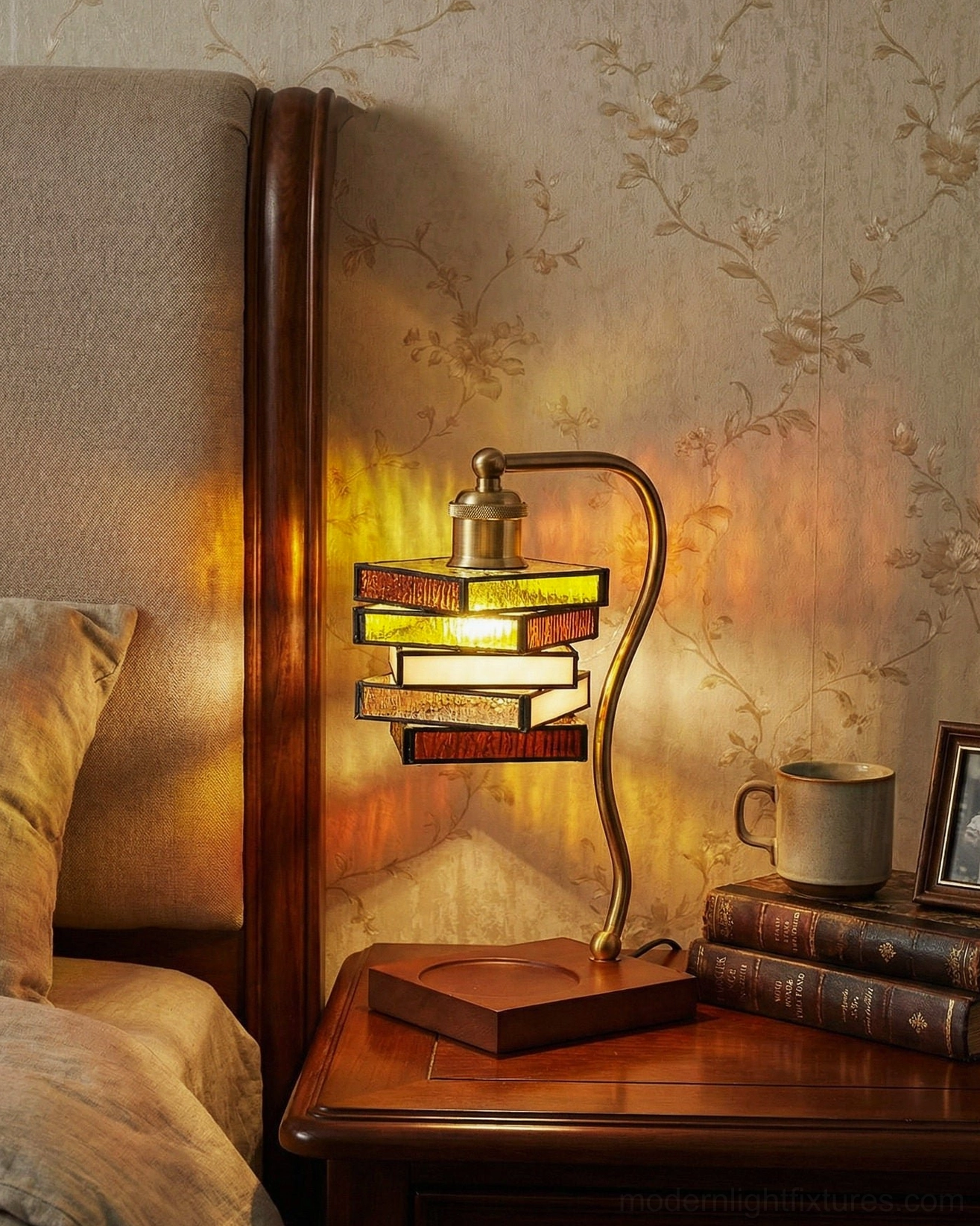 Stained glass table lamp positioned on bedroom nightstand with books and coffee mug, warm ambient lighting