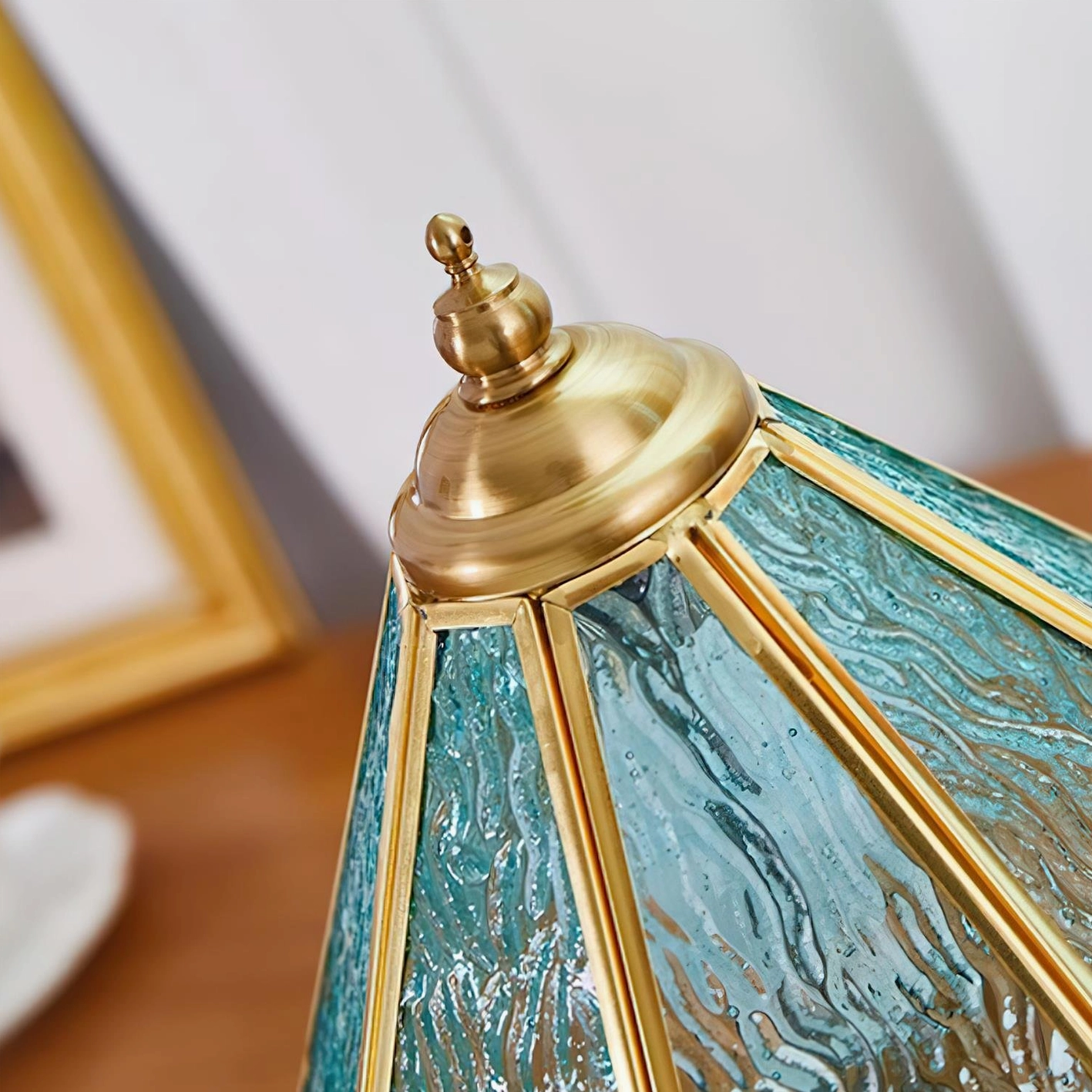 Side close-up detail of brass edged stained glass panel showing rippled blue texture and gold trim craftsmanship