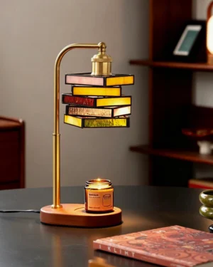 Flame-free candle warmer lamp styled on dark academia study desk with books and warm vintage lighting, three-quarter angle view