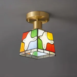 Stained glass flush mount ceiling light with colorful dove design and square glass panels, side angle