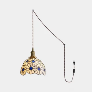 Handcrafted stained glass floral pendant light with brass fixture and twisted power cord, studio side view
