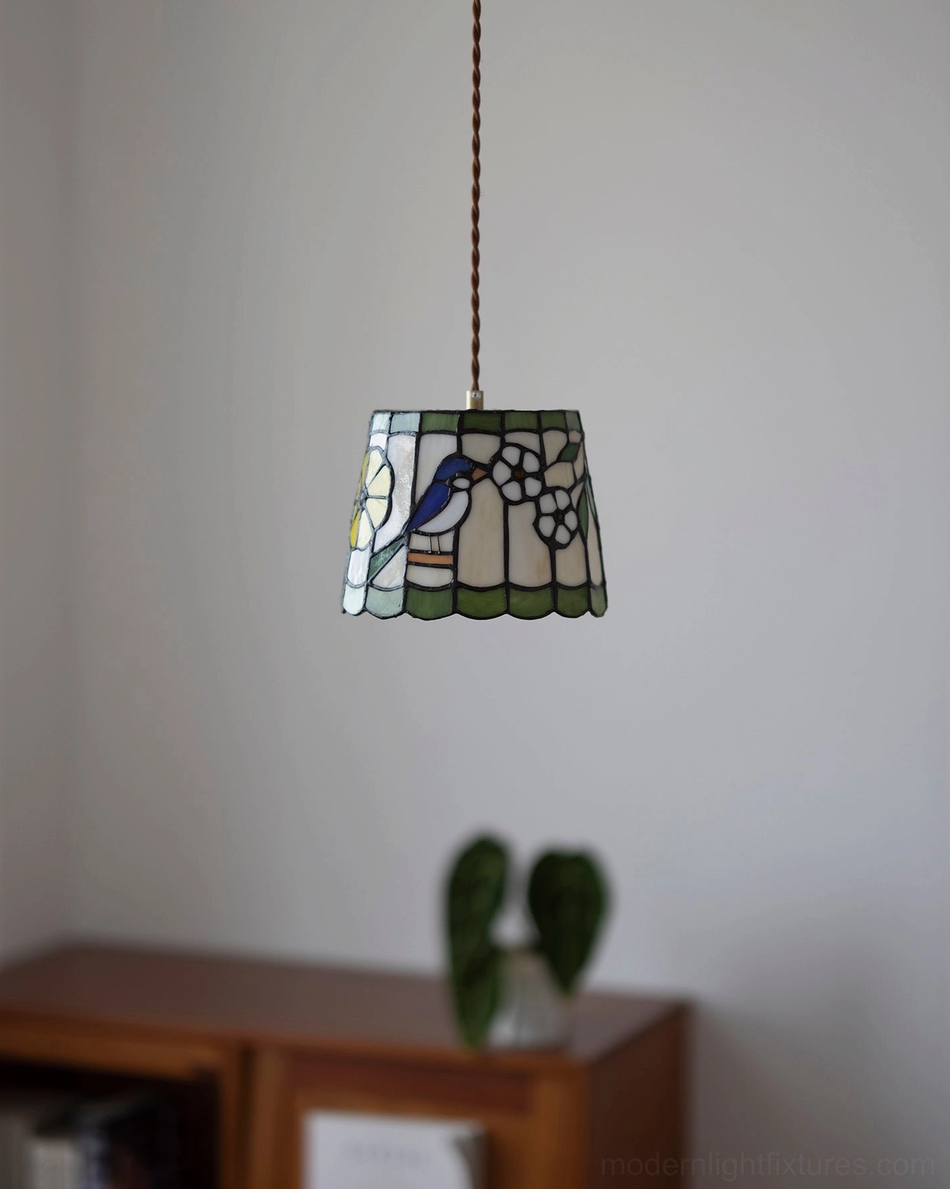 Green-accented hand-assembled stained glass shade pendant lamp with decorative pattern and brass hardware