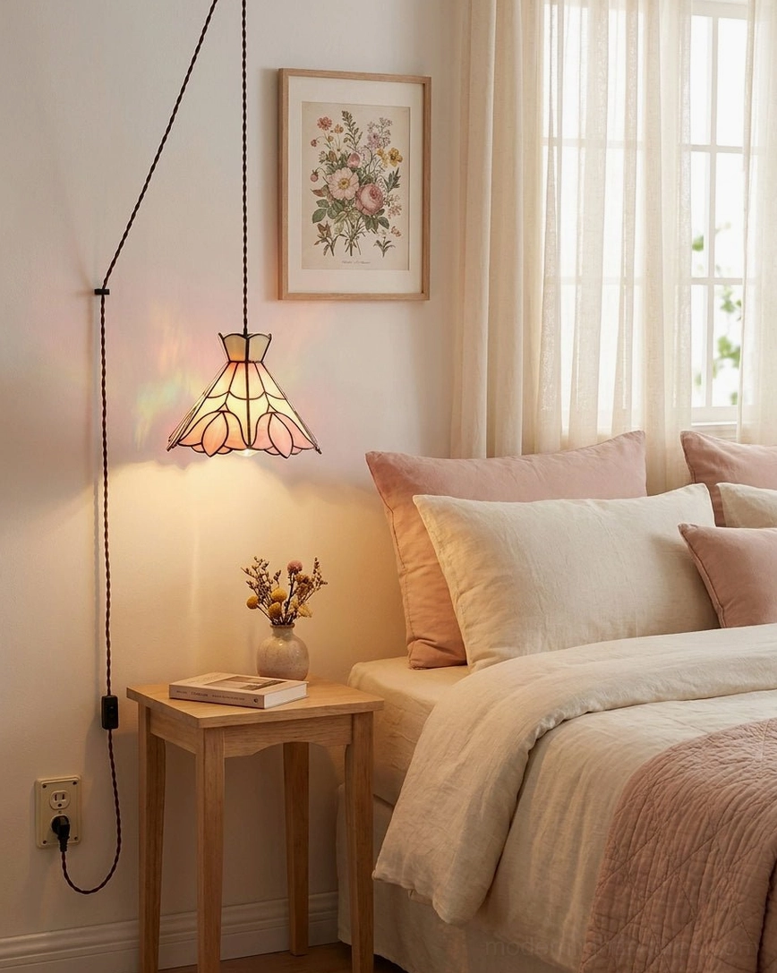 Stained glass plug-in pendant light in cozy bedroom corner above nightstand with warm ambient lighting, soft wall art, and cottagecore vintage bedside setting
