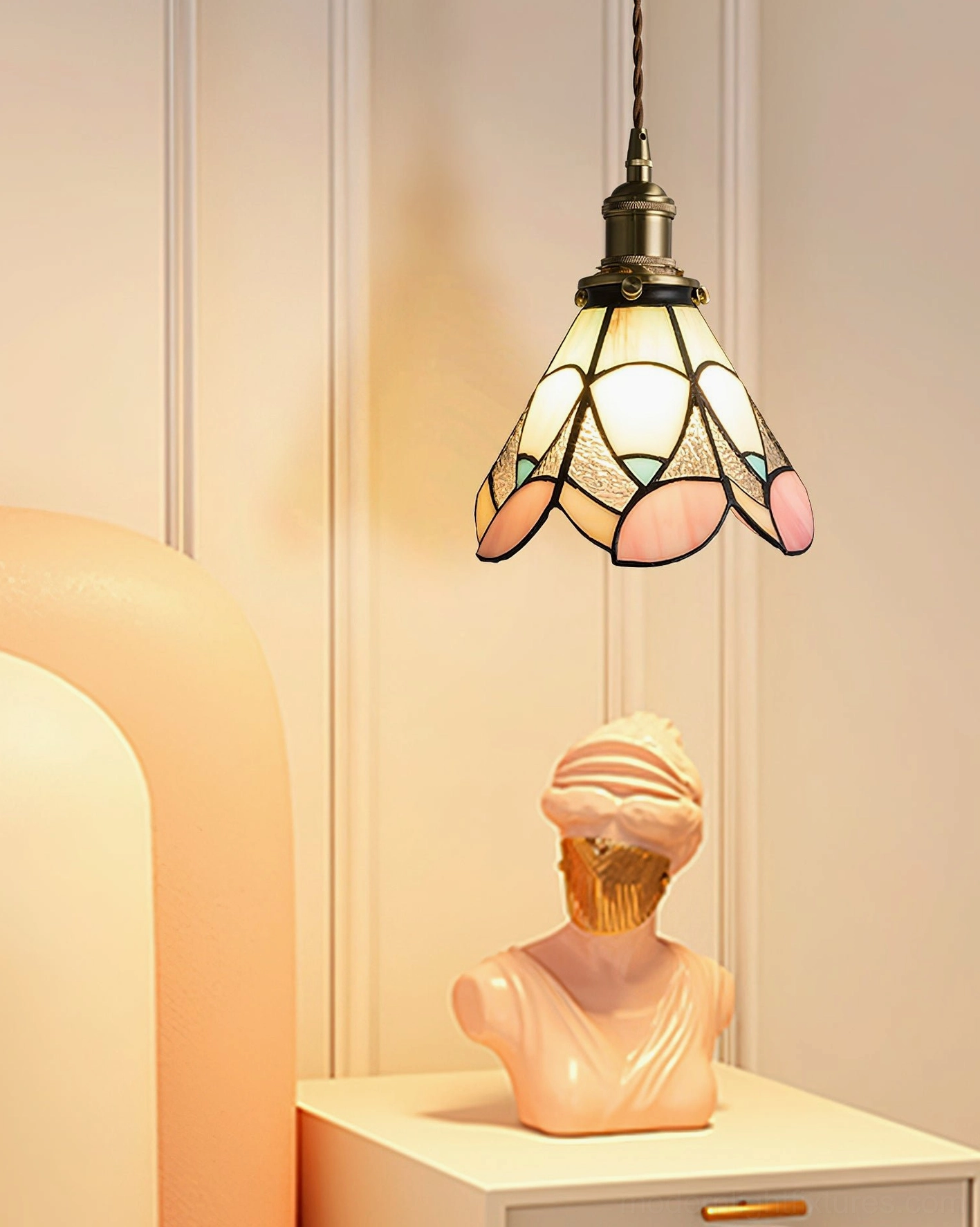 Stained glass pendant light with petal design mounted above bedroom nightstand, vintage-inspired aesthetic