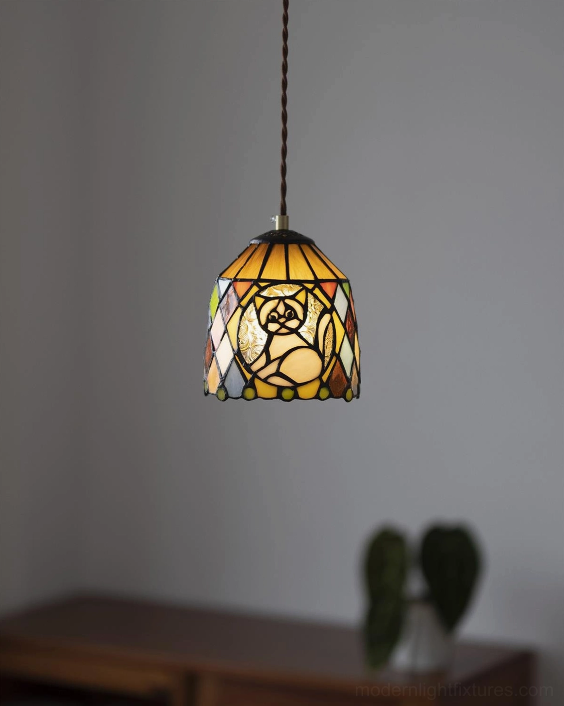 Stained glass pendant lamp showing detailed glass panel work with artistic animal illustrations