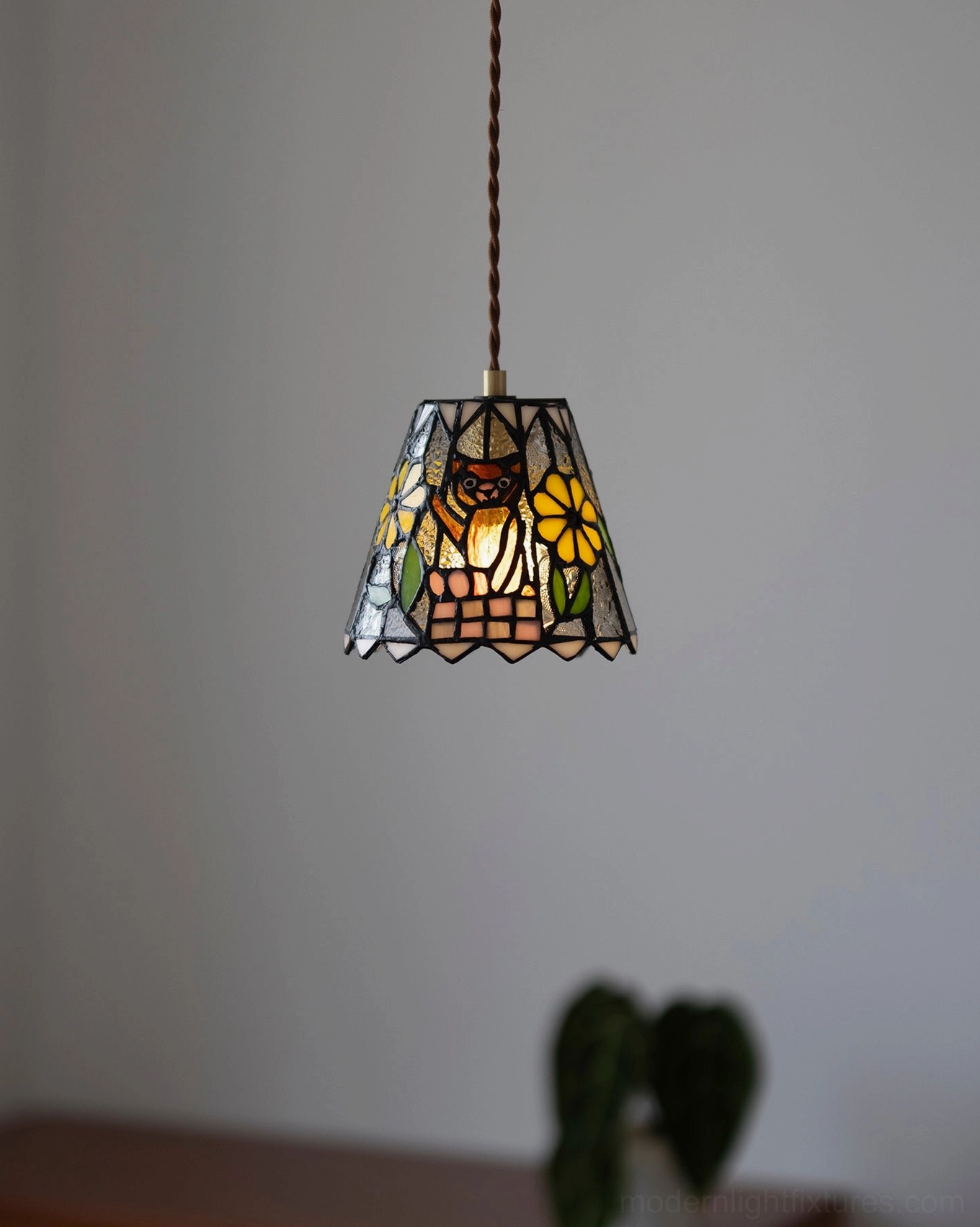 Handcrafted stained glass pendant light in home office creating creative inspiring warm illumination