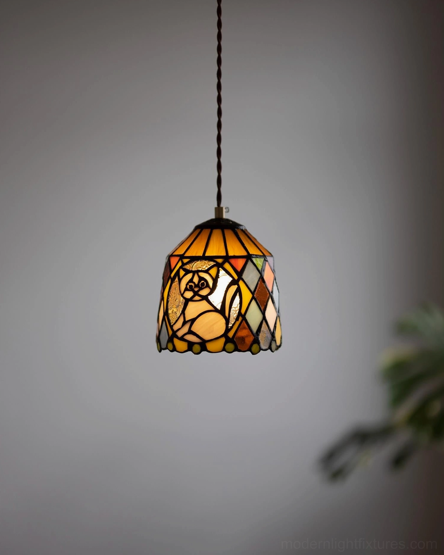 Stained glass pendant light fixture showing warm amber and jewel tone color palette