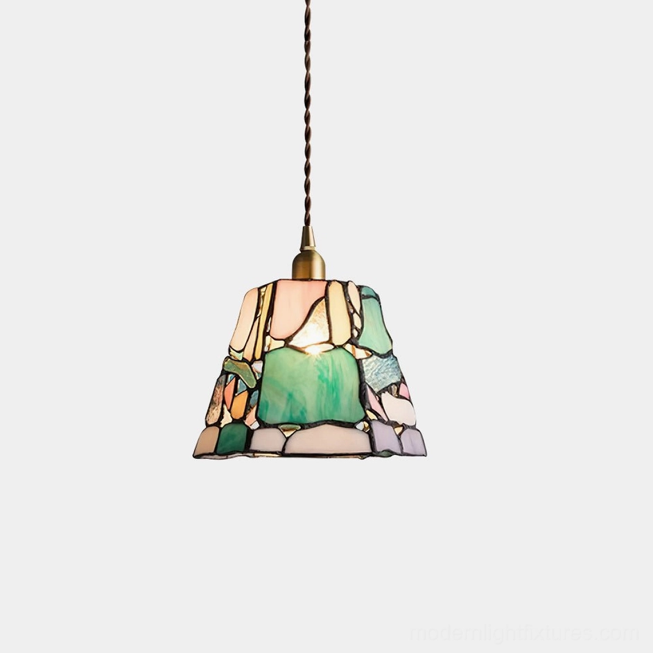 Handcrafted stained glass pendant light with trapezoid shape and mixed colorful glass panels, brass hardware, studio front view