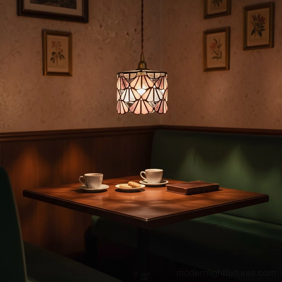 Warm-toned stained glass pendant lamp creating ambient light in retro restaurant booth setting
