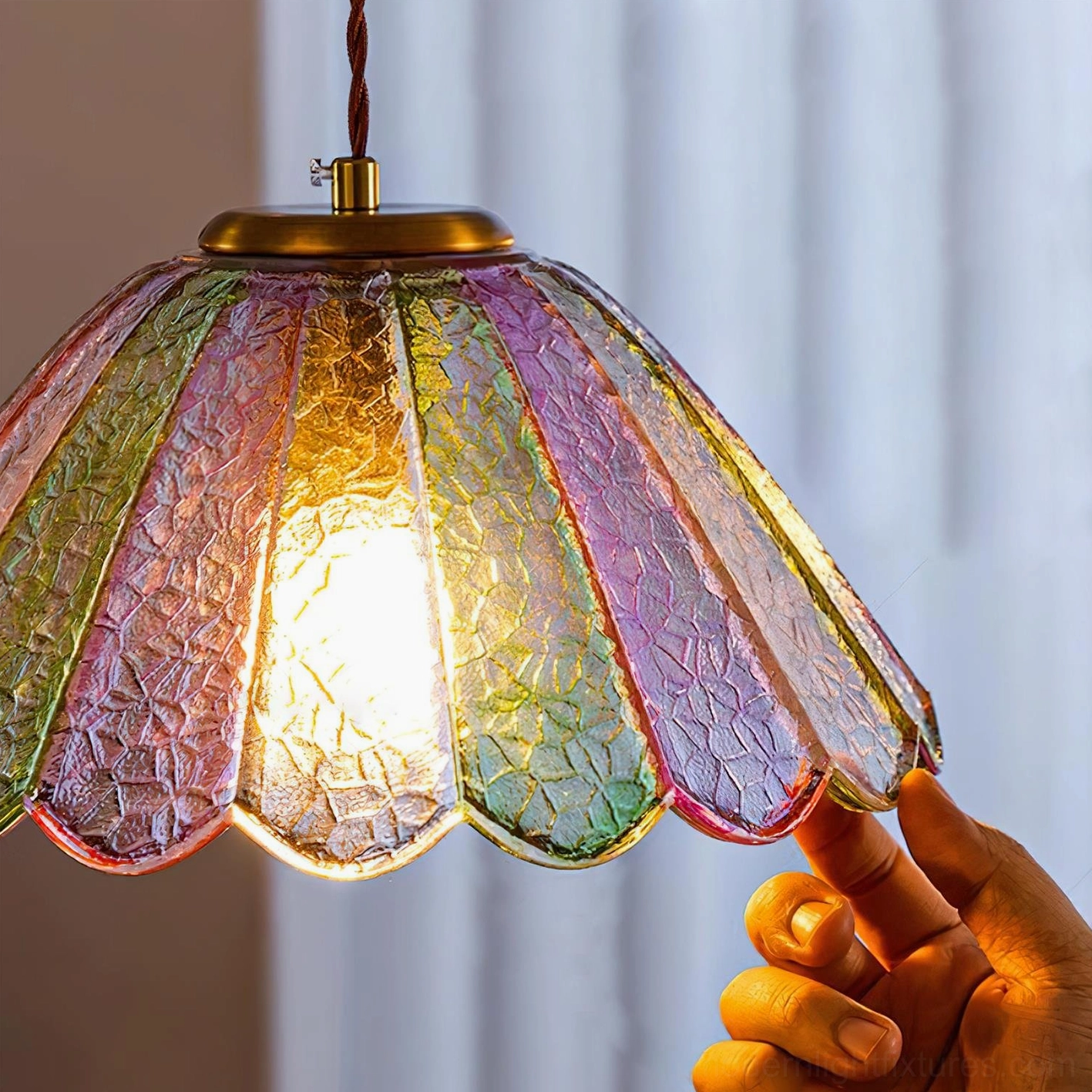 Handcrafted stained glass shade close-up, showing scalloped ribbed texture and gradient color detail