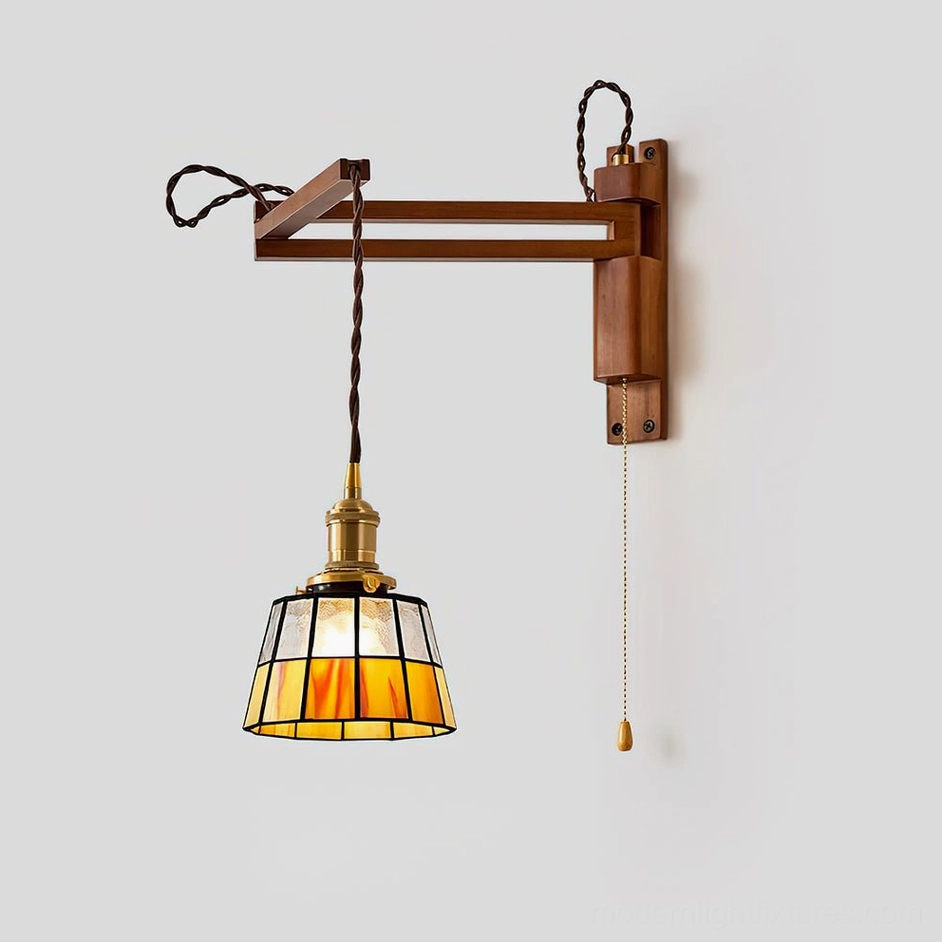Artistic stained glass wall sconce casting decorative light patterns and shadows on interior wall surface, geometric grid creating dynamic luminous effect
