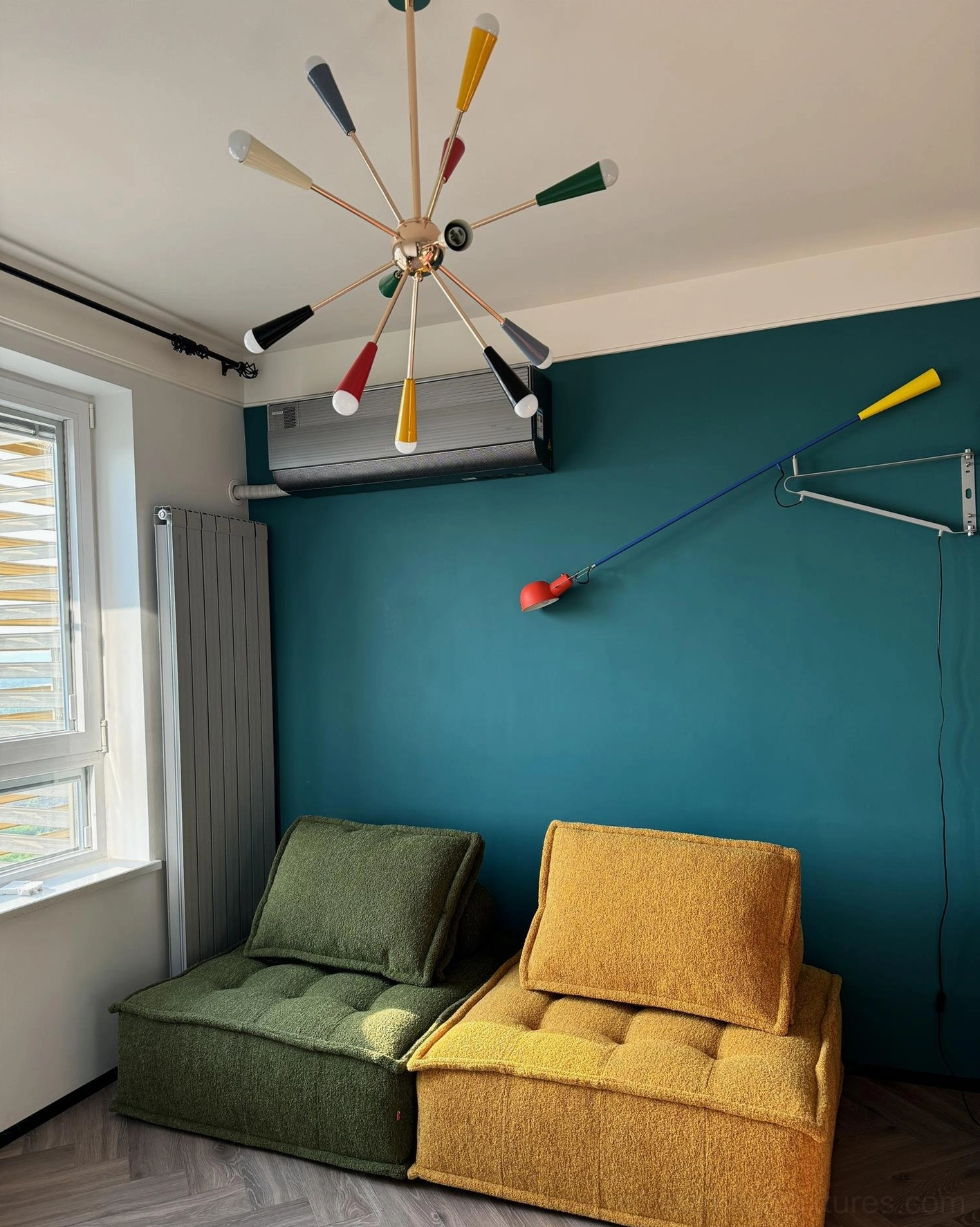 Sputnik burst chandelier ceiling view in retro living room with teal wall decor