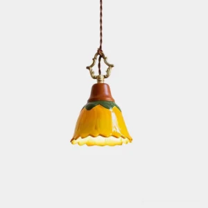 Stella hand-glazed ceramic pendant light with scalloped sunflower shade, front overhead view on white background