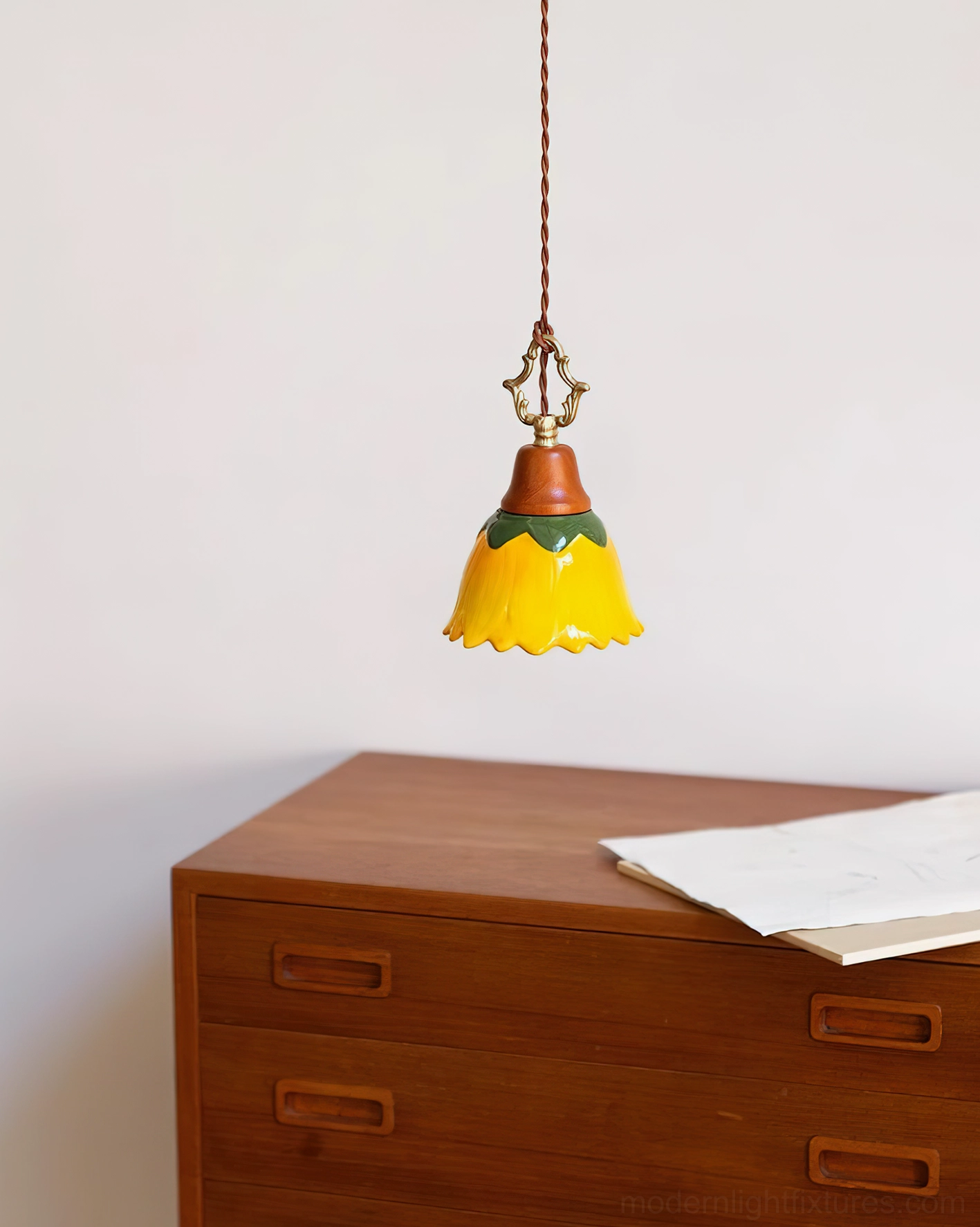 Stella ceramic pendant light hanging above wooden dresser in vintage home setting