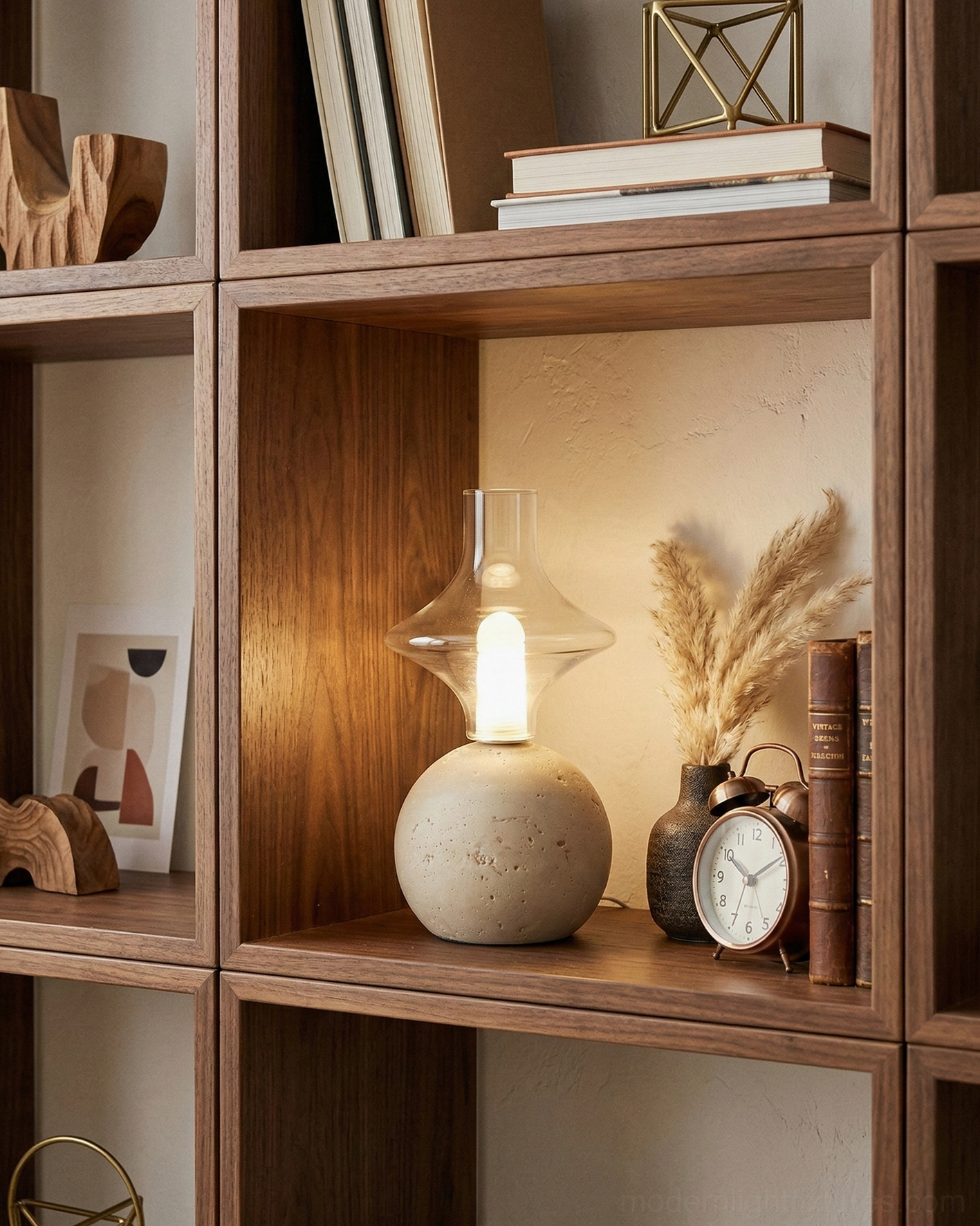 Stilla Orb travertine lamp displayed on wooden open bookshelf with warm minimalist aesthetic