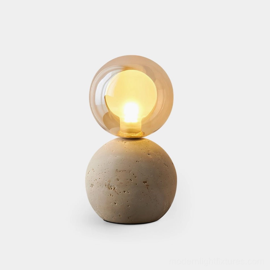 Stilla Orb travertine table lamp with spherical base and crystalline glass shade, front close-up studio shot