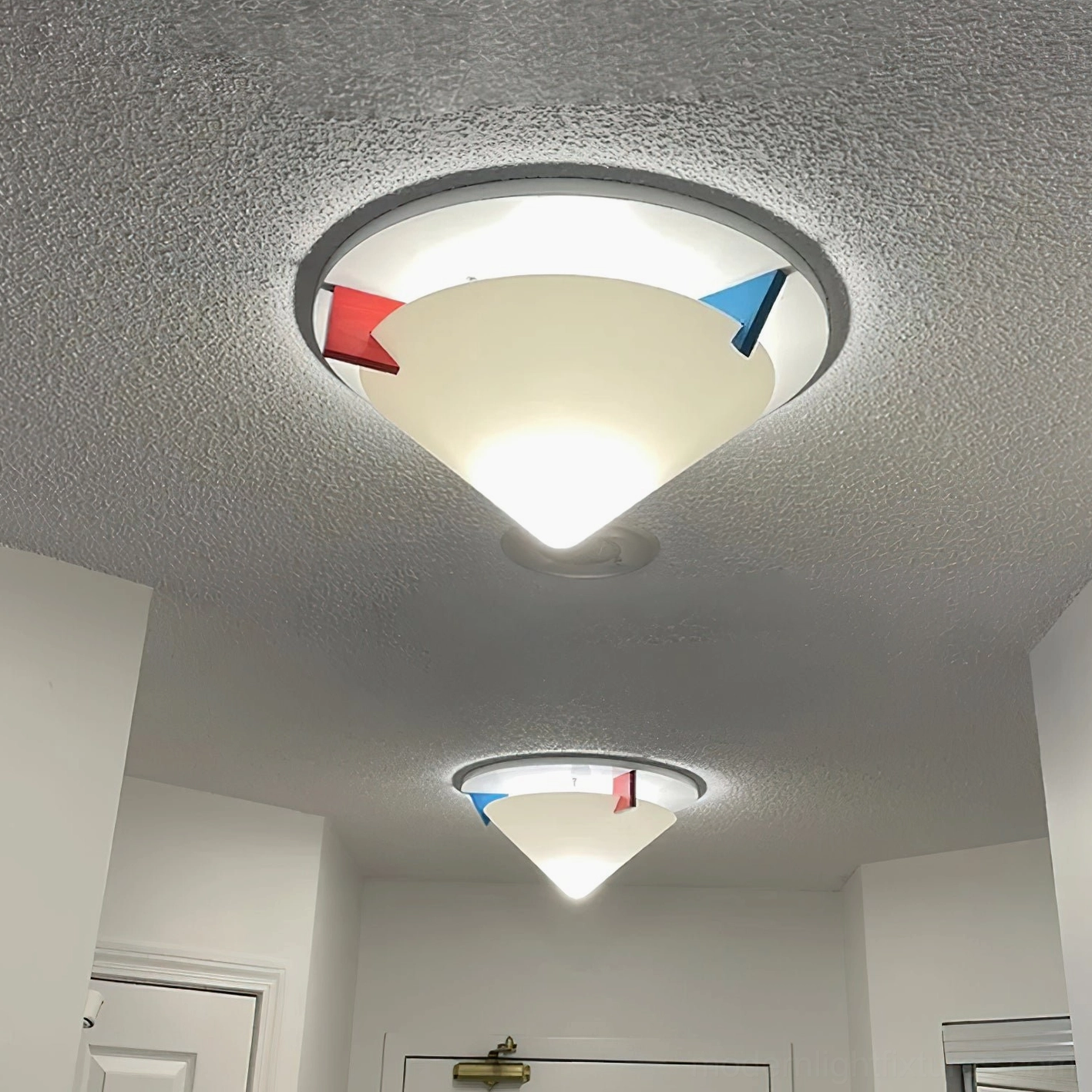Stoja ceiling lamps installed in home hallway creating warm ambient lighting with matching dual fixtures on textured popcorn ceiling