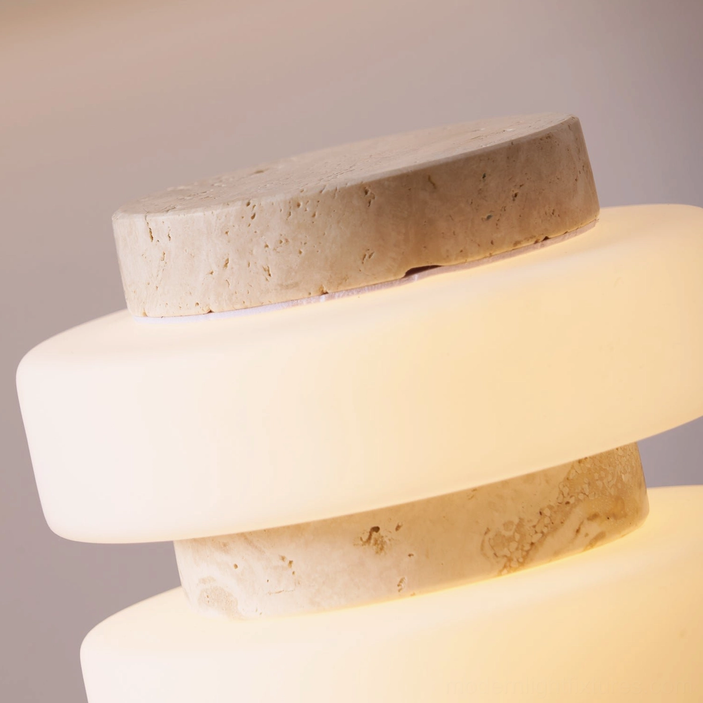 Strata contemporary LED table lamp with frosted acrylic rings and natural stone base in modern setting