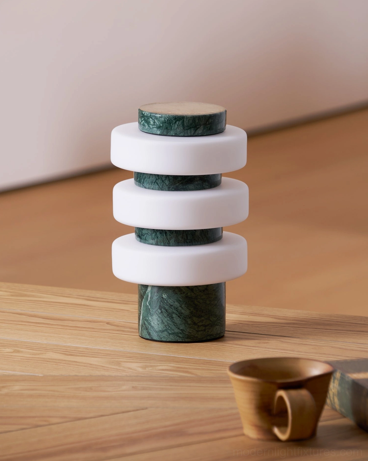 Strata modern table lamp illuminated in ambient lighting showing warm glow and sculptural silhouette