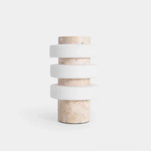 Strata modern table lamp with stacked frosted acrylic rings and travertine base, front studio view showing sculptural LED lighting design