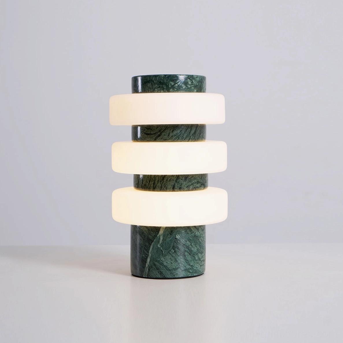Strata sculptural table lamp with natural travertine base paired with modern minimalist room decor
