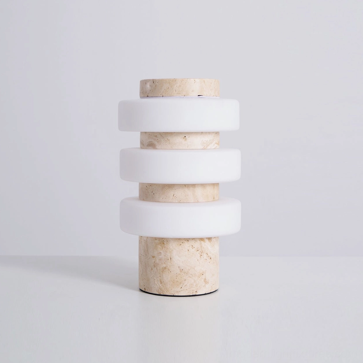 Strata table lamp in white and beige travertine finish showcasing warm neutral color palette