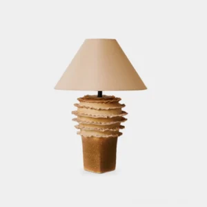 Stratified ceramic table lamp with layered organic base in beige, front view against white background