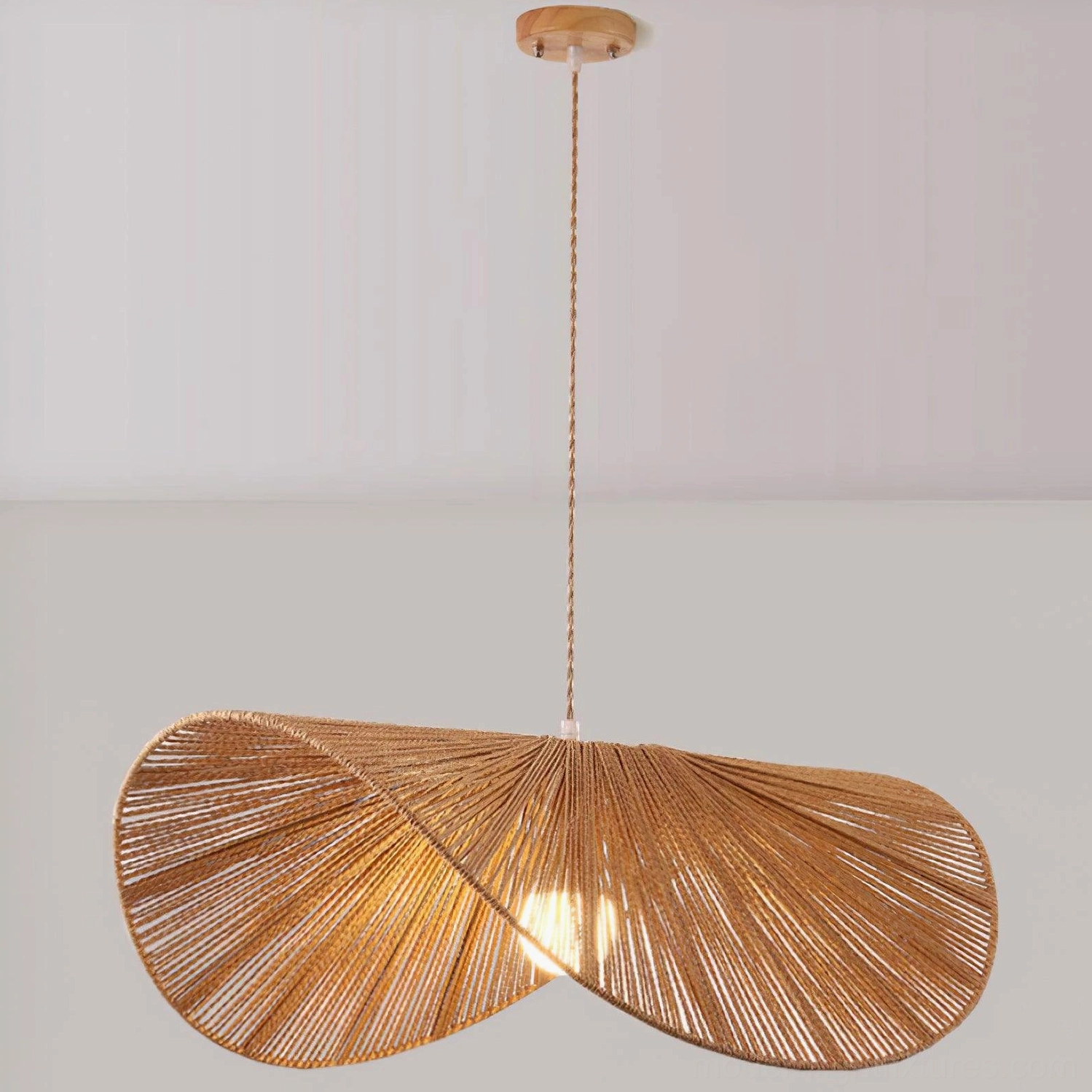 Woven straw hat pendant light suspended at optimal height above dining table with place settings