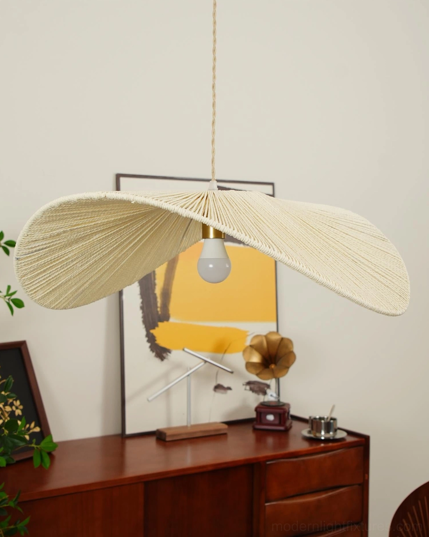 Full view of woven straw hat pendant light fixture showing interlaced rope architecture and form