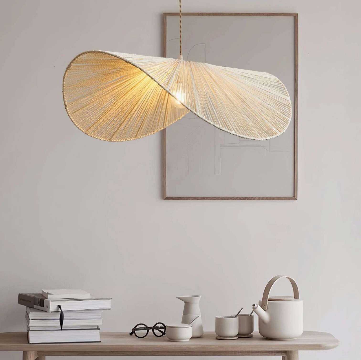 Woven straw hat pendant light in neutral tones providing task and ambient lighting in residential kitchen
