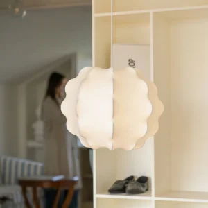 Striata pendant light installed in modern entryway with neutral home interior decor and shoe storage