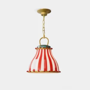 Striped glass pendant lamp with red and white circus pattern and brass chain on white background