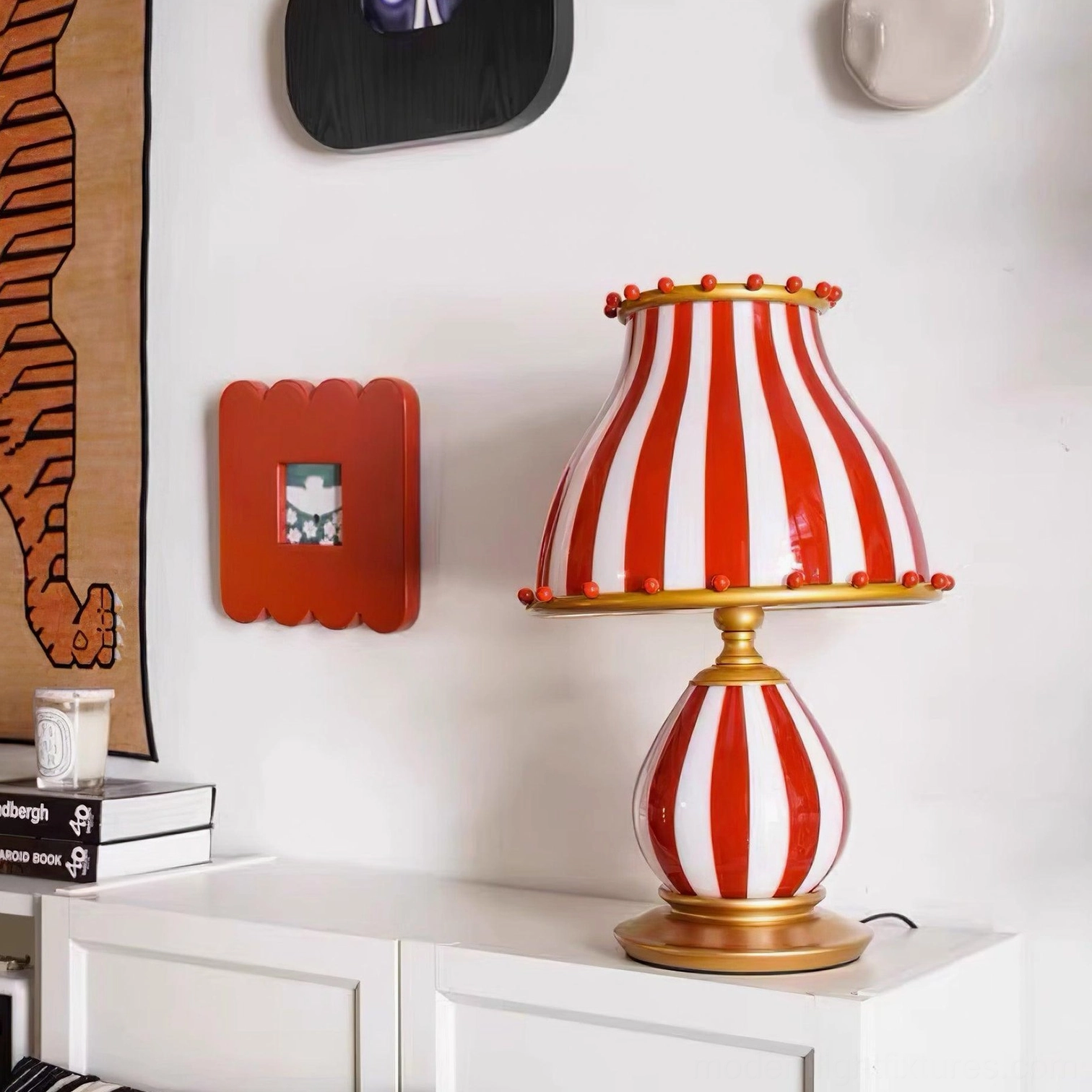 Striped table lamp with warm golden base accent piece for living spaces
