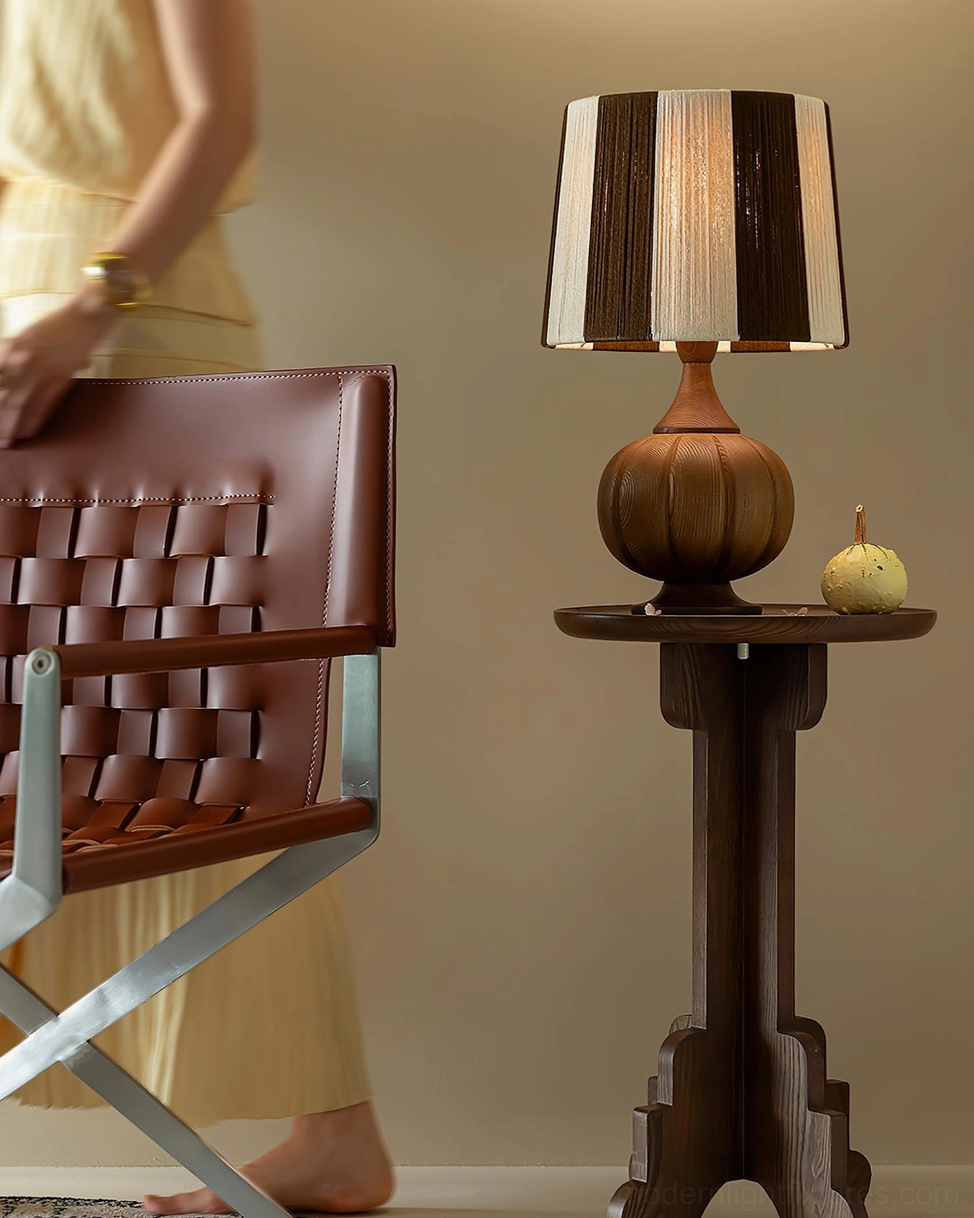 Striped wooden table lamp illuminated in cozy reading nook with vintage home decor accessories