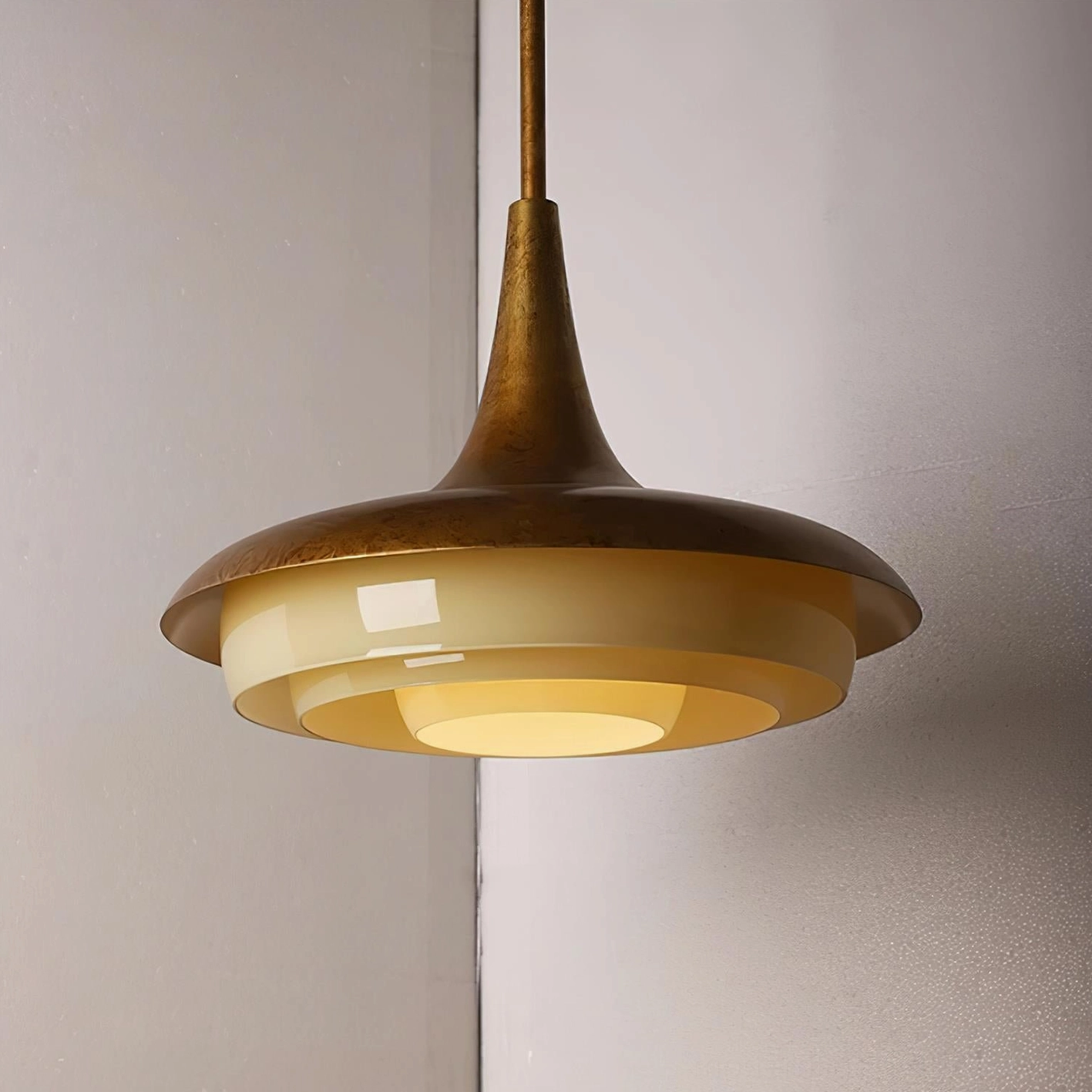 Stylish aged brass pendant light with creamy yellow glass, room ambiance and lighting effect showcase