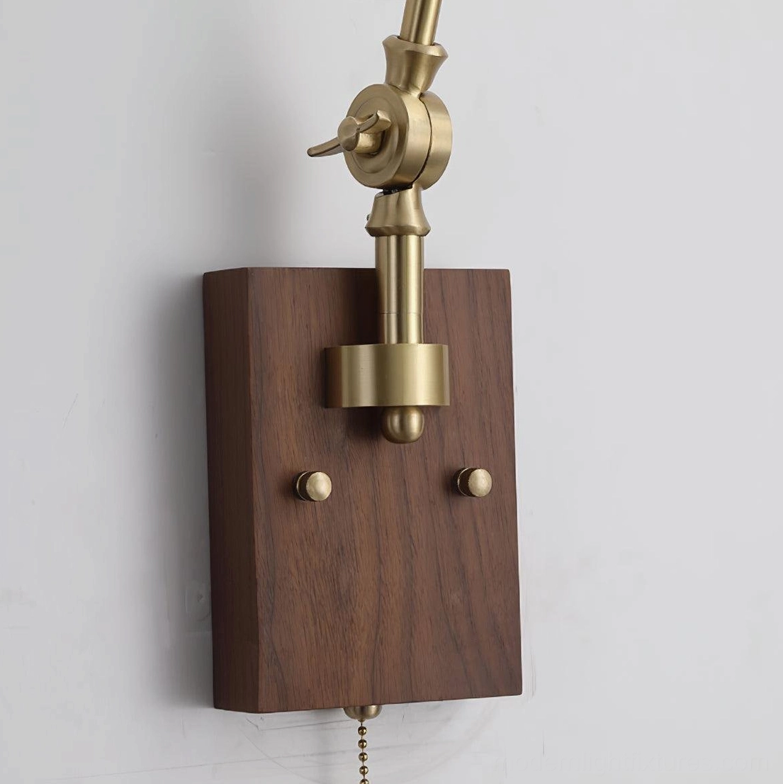 Stylish brass swing arm wall sconce with green glass shade suitable for home office, bedroom, and living room ambient and task lighting applications