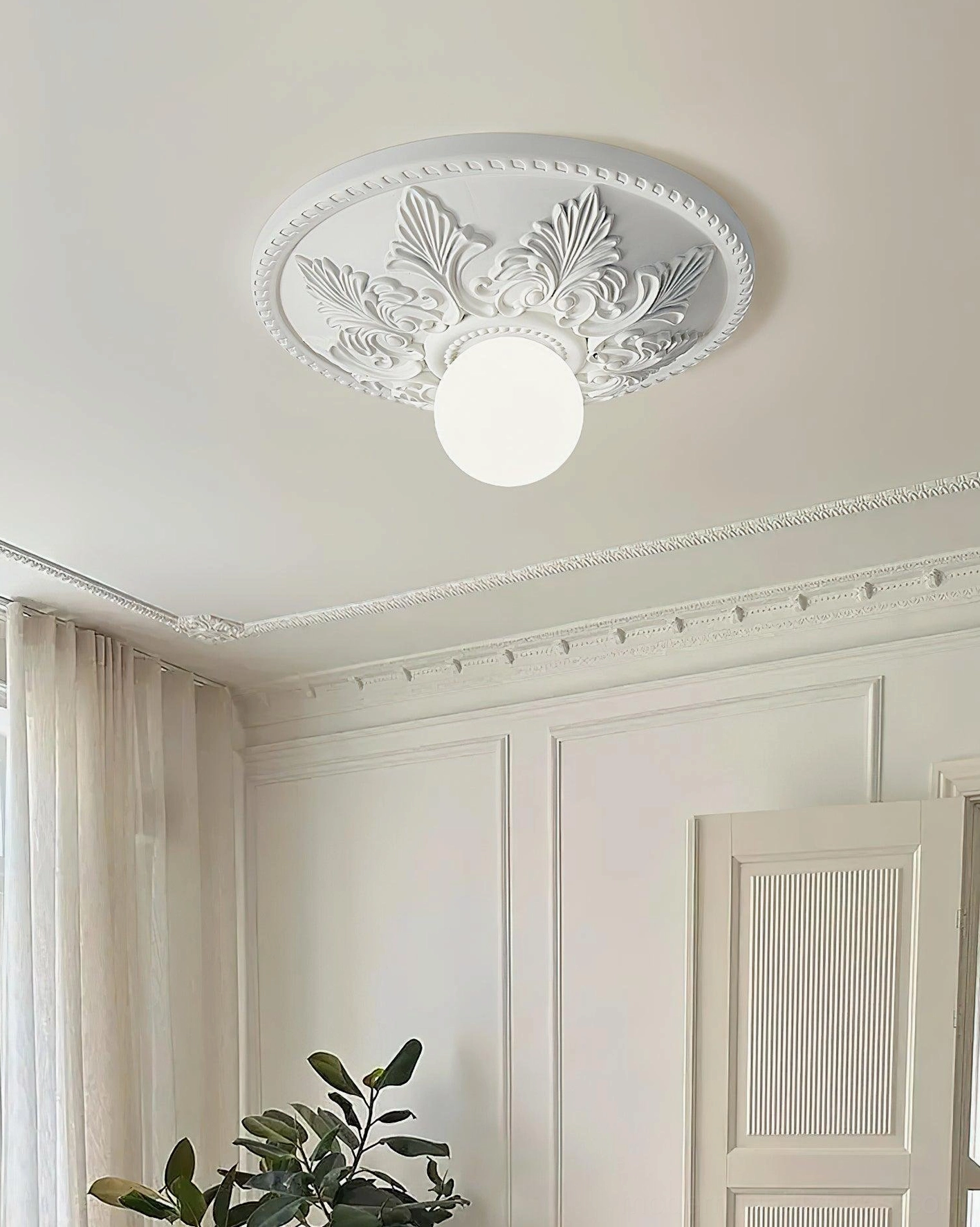 Suilven white ornate ceiling light with floral carved base providing warm ambient lighting in paneled living room