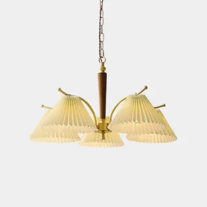 5-head pleated fabric chandelier with brass frame and walnut wood center pole in studio setting, white pleated shades with vintage mid-century modern design