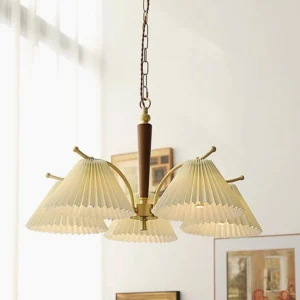 5-head pleated chandelier displayed in modern living room interior with wall art, brass hardware and dark wood stem creating mid-century modern lighting ambiance