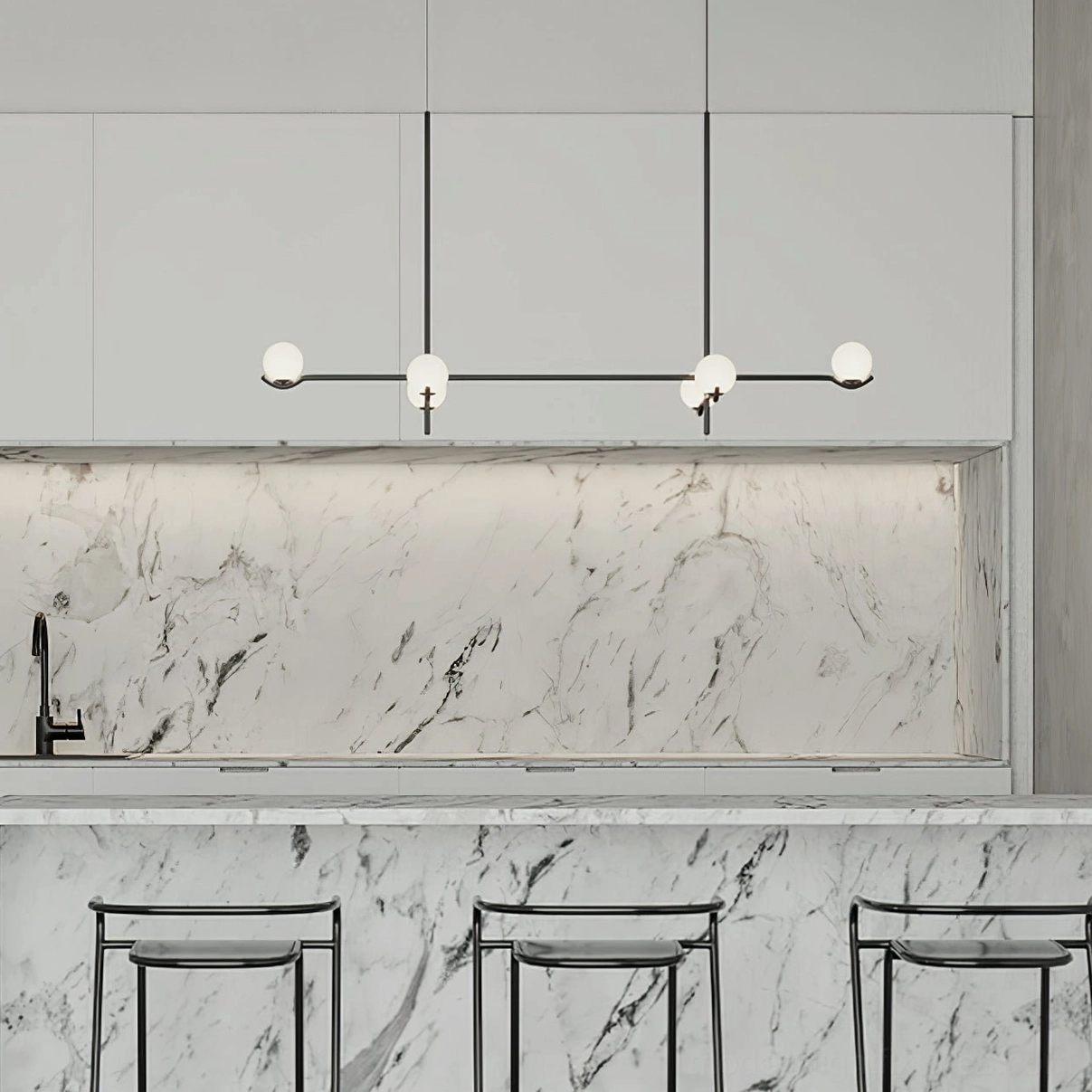 Linear multi-arm modern pendant chandelier with frosted white glass globes over marble kitchen counter
