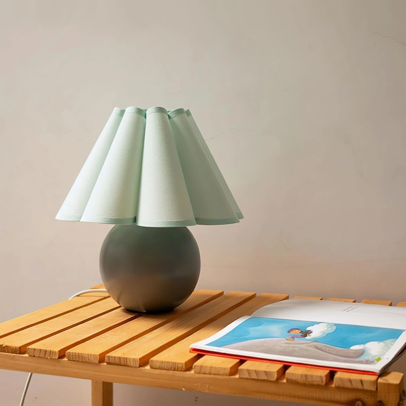 Contemporary sunburst table lamp with ceramic base demonstrating soft diffused pleated fabric shade lighting effect