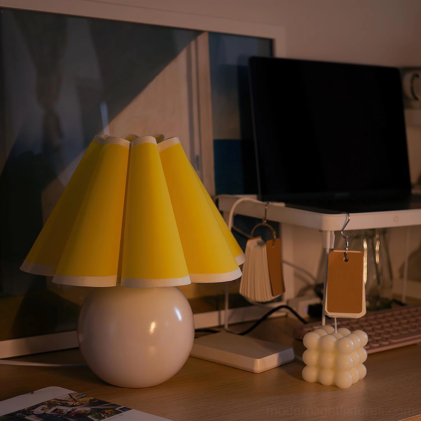 Modern sunburst table lamp with white base in minimalist home office on desk workspace