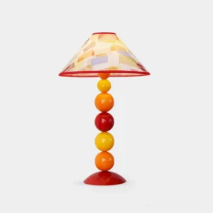 Sunset Harmony colorful beaded table lamp with red-trimmed conical shade and warm-toned spherical post on white background - modern decorative lighting