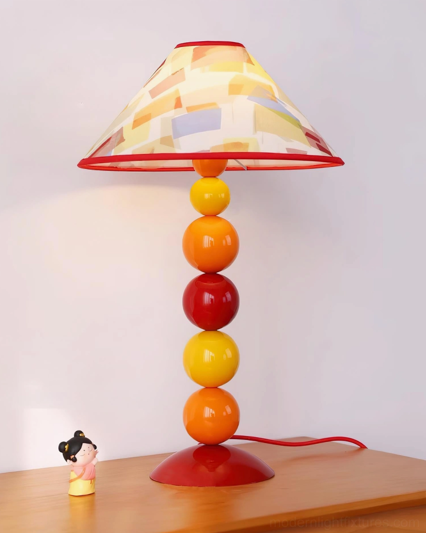 Artistic colorful beaded table lamp on wooden surface - bohemian contemporary home interior styling